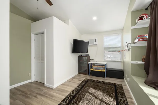 a bedroom with furniture and a flat screen tv