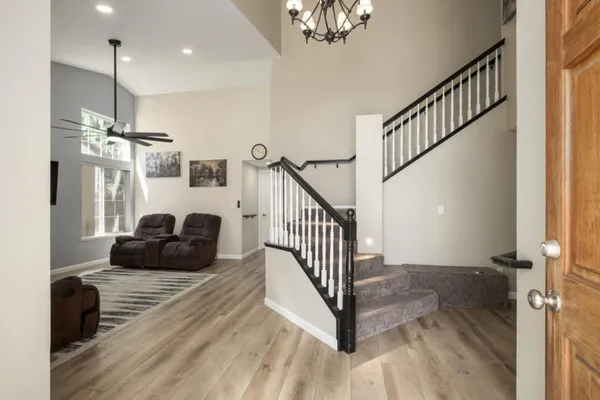 a view of entryway and hall with wooden floor