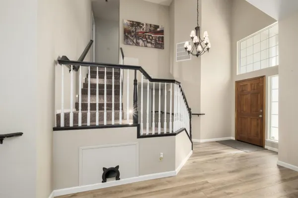 a view of entryway and hall with wooden floor