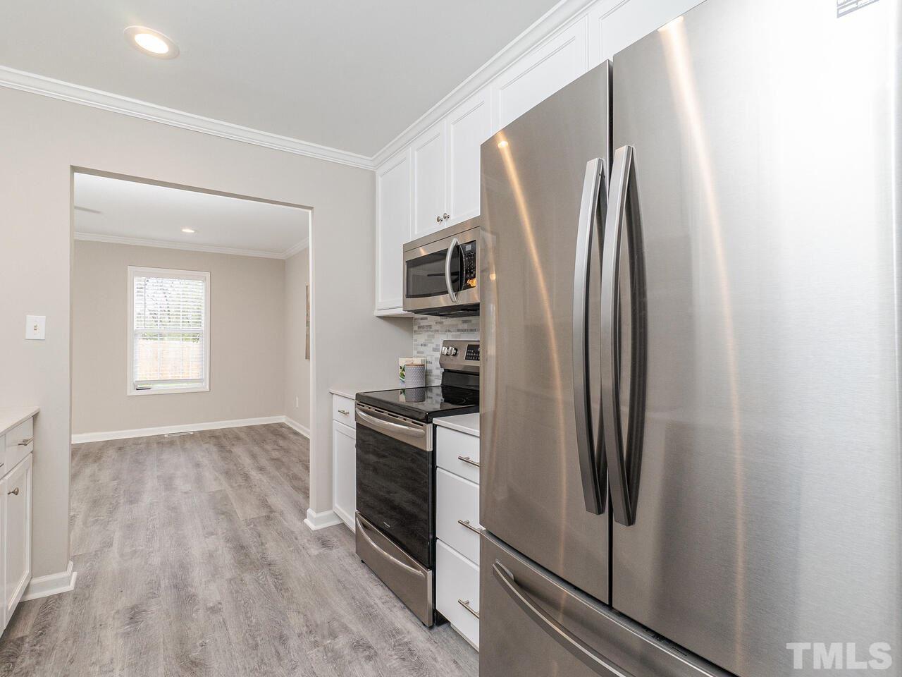 1507 Pender Street Raleigh, NC 27610 - Photo 11 of 30 a kitchen with stainless steel appliances a refrigerator sink and microwave