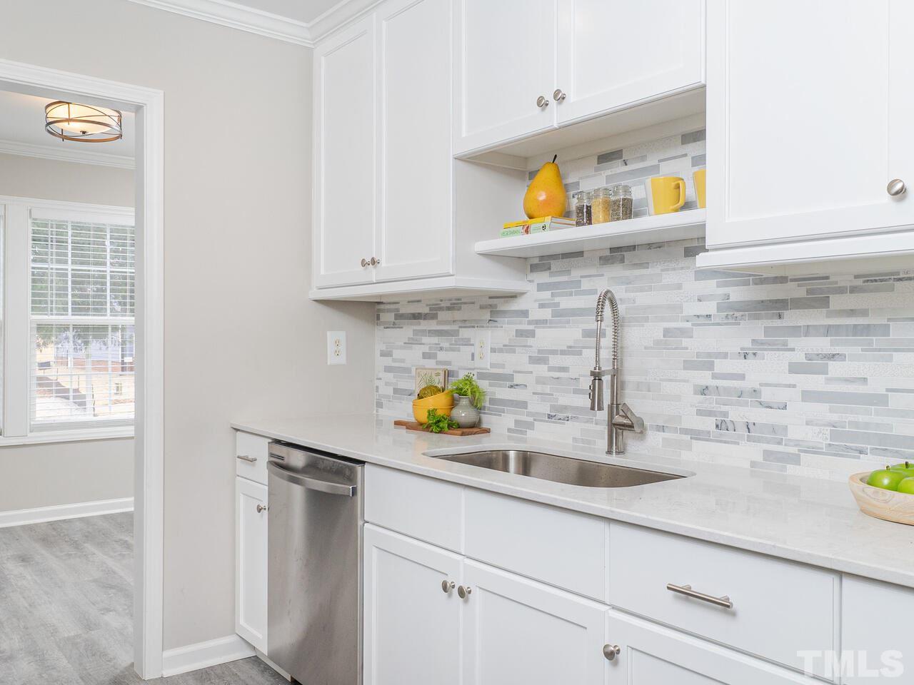 1507 Pender Street Raleigh, NC 27610 - Photo 13 of 30 a kitchen with a sink a counter and cabinets