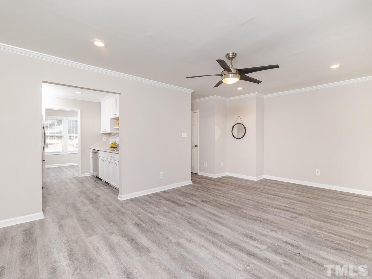 1507 Pender Street Raleigh, NC 27610 - Photo 17 of 30 a view of a livingroom with a hardwood floor and a ceiling fan