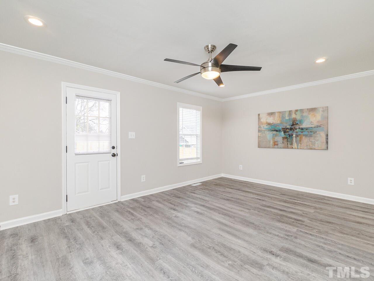 1507 Pender Street Raleigh, NC 27610 - Photo 18 of 30 a view of an empty room with a window and wooden floor