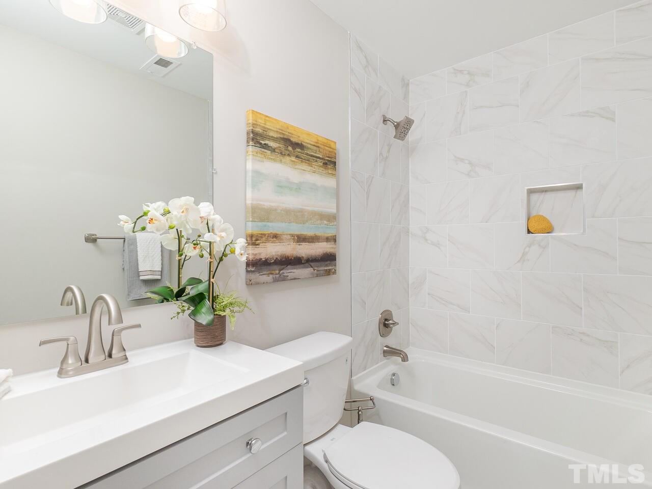 1507 Pender Street Raleigh, NC 27610 - Photo 22 of 30 a bathroom with a sink a toilet and shower