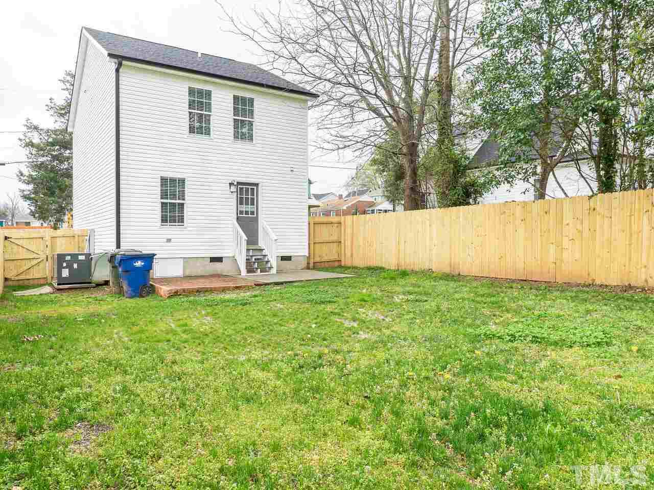 1507 Pender Street Raleigh, NC 27610 - Photo 24 of 30 a view of backyard with wooden fence and large trees