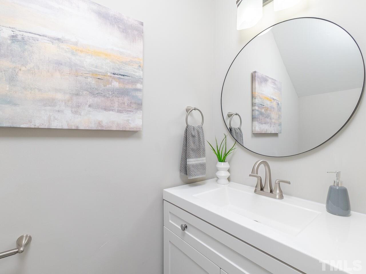 1507 Pender Street Raleigh, NC 27610 - Photo 6 of 30 a bathroom with a sink and a mirror