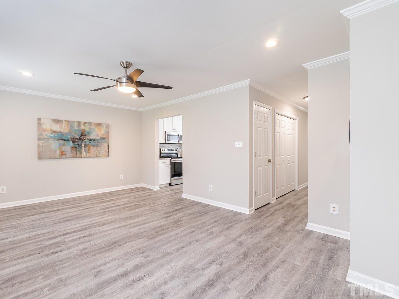 1507 Pender Street Raleigh, NC 27610 - Photo 8 of 30 a view of an empty room with wooden floor and a window