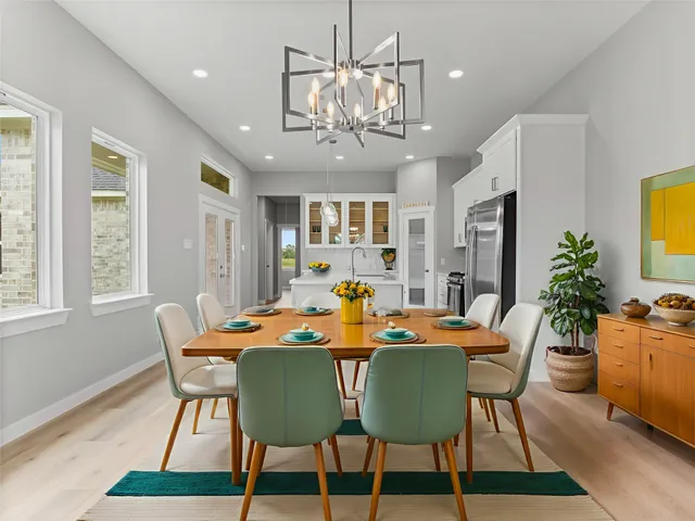 a view of a dining room with furniture and chandelier