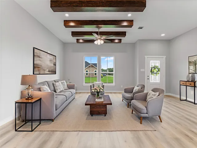 a living room with furniture and a chandelier