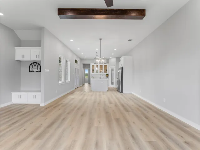 a view of a kitchen with a sink and a refrigerator