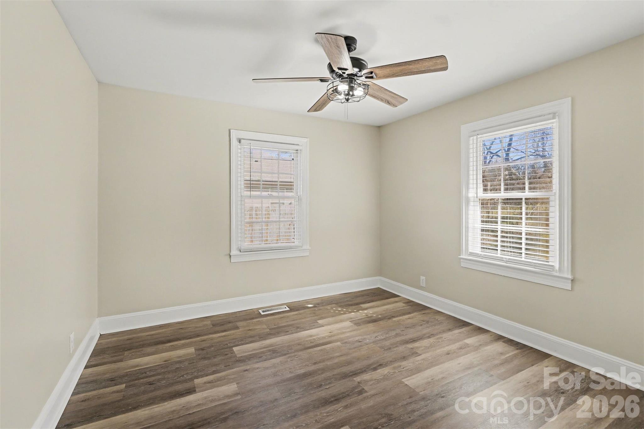 614 North Rhyne Street Gastonia, NC 28054 - Photo 21 of 29 a view of an empty room with wooden floor and a window