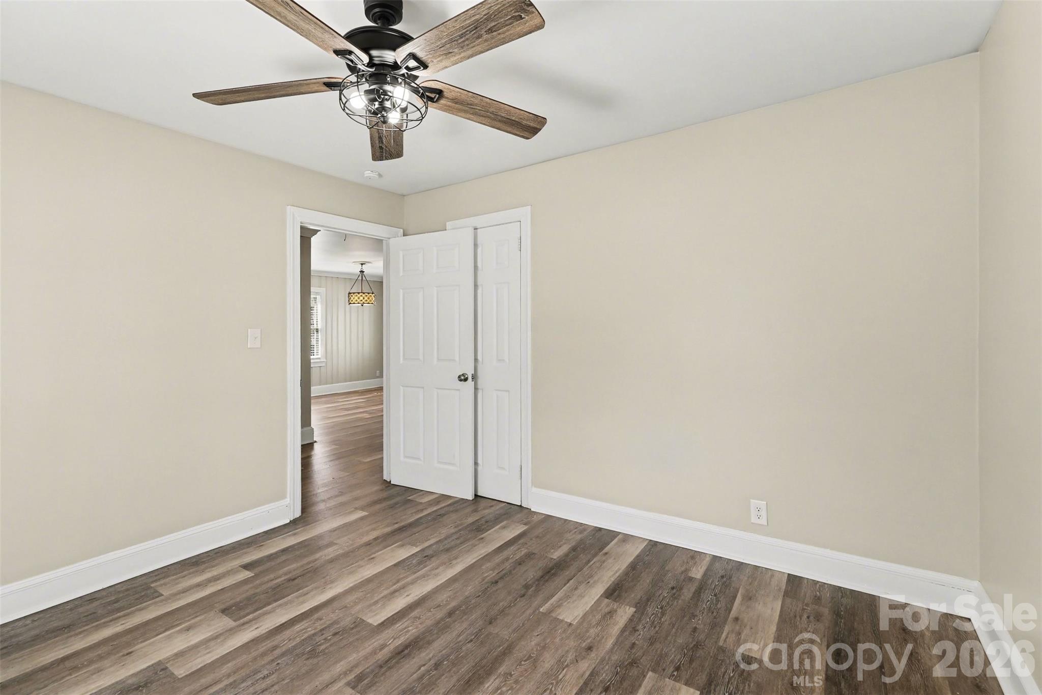 614 North Rhyne Street Gastonia, NC 28054 - Photo 22 of 29 a view of a room with wooden floor and a ceiling fan