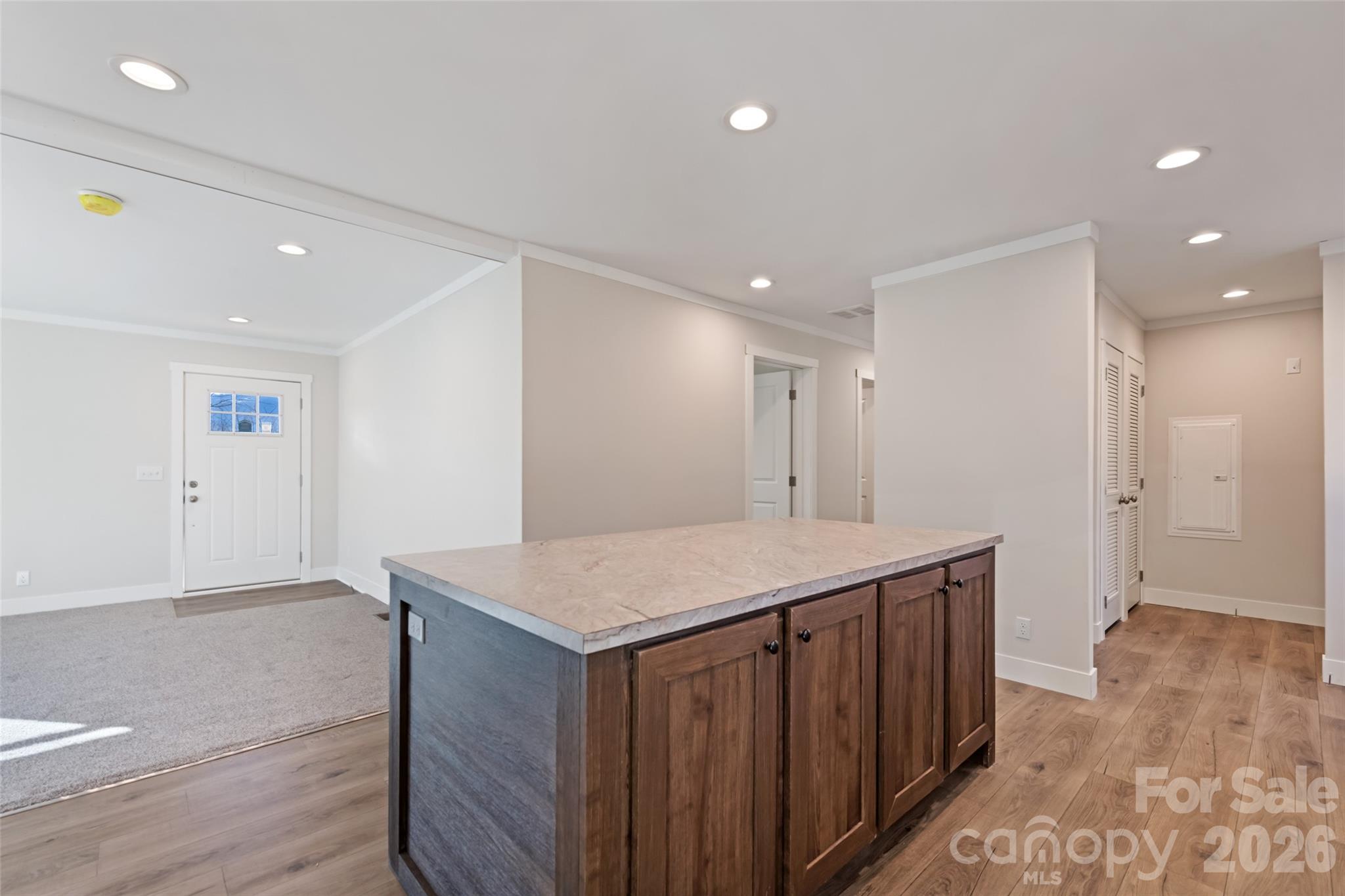77 Geiranger Drive Clyde, NC 28721 - Photo 12 of 29 a kitchen with a wooden floor and cabinetry