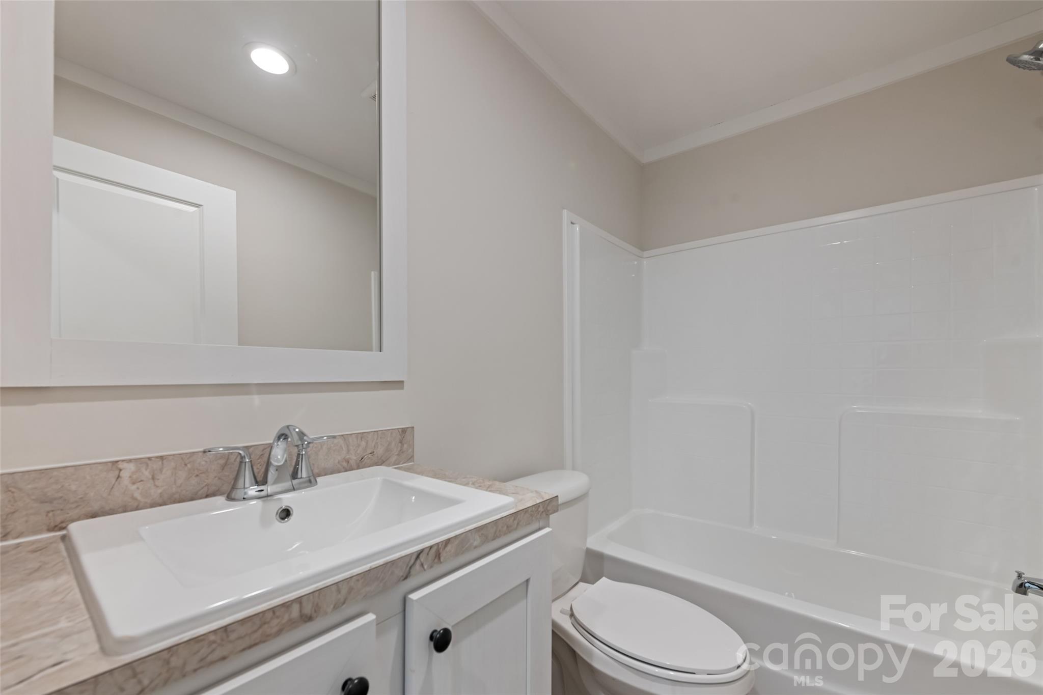 77 Geiranger Drive Clyde, NC 28721 - Photo 19 of 29 a bathroom with a sink toilet vanity and shower