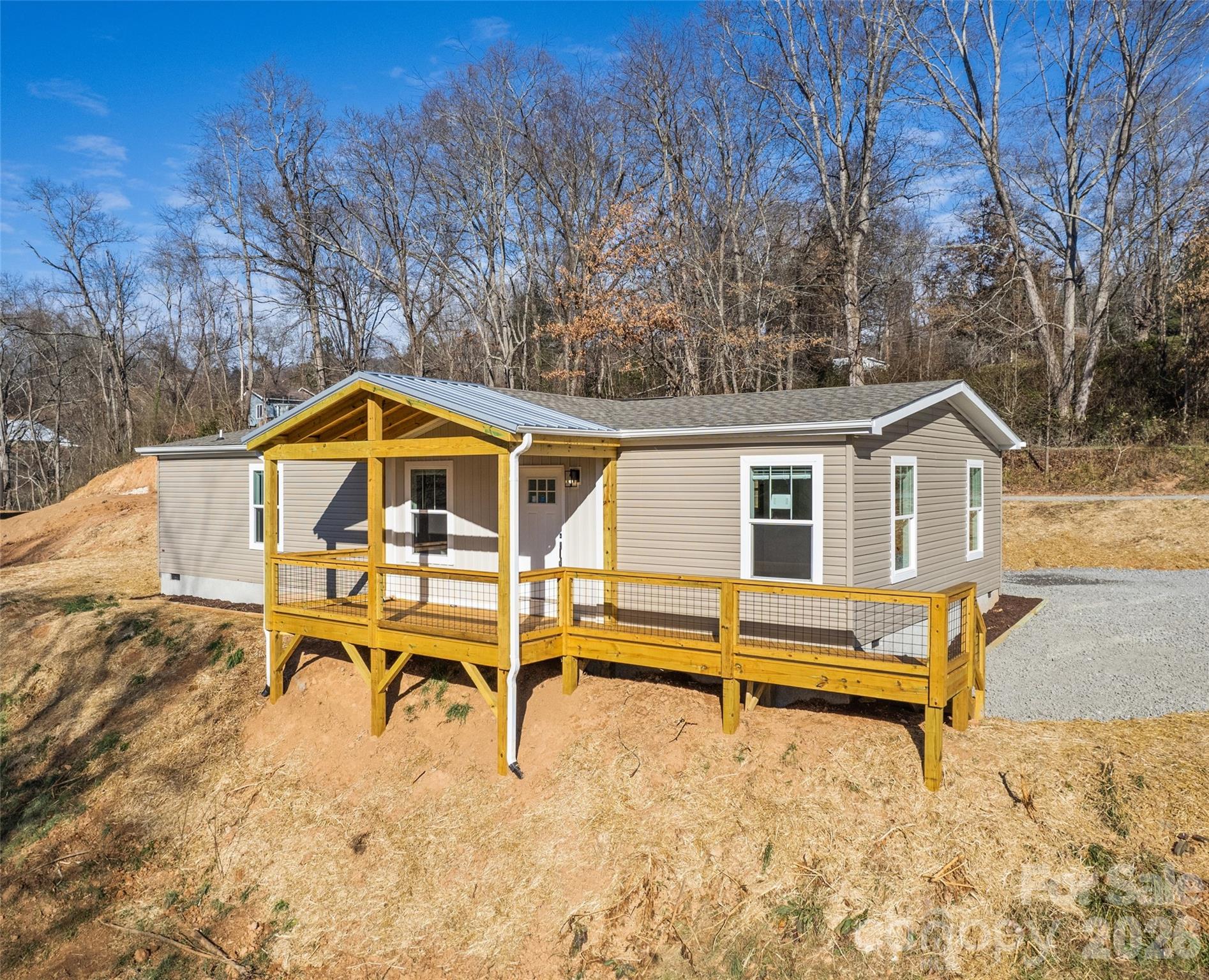 77 Geiranger Drive Clyde, NC 28721 - Photo 2 of 29 a house view with a wooden roof and outdoor seating