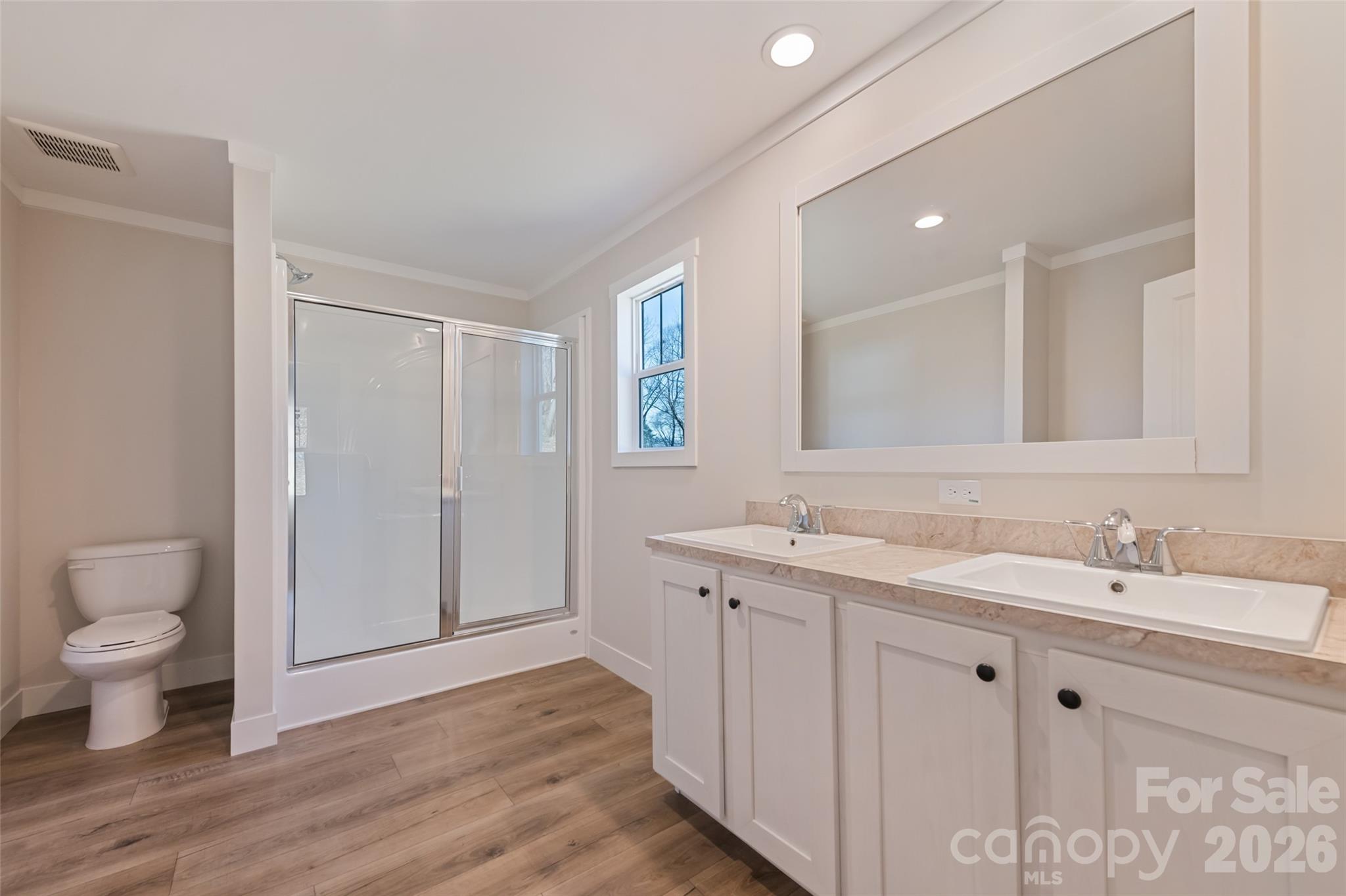 77 Geiranger Drive Clyde, NC 28721 - Photo 24 of 29 a spacious bathroom with a toilet sink and mirror