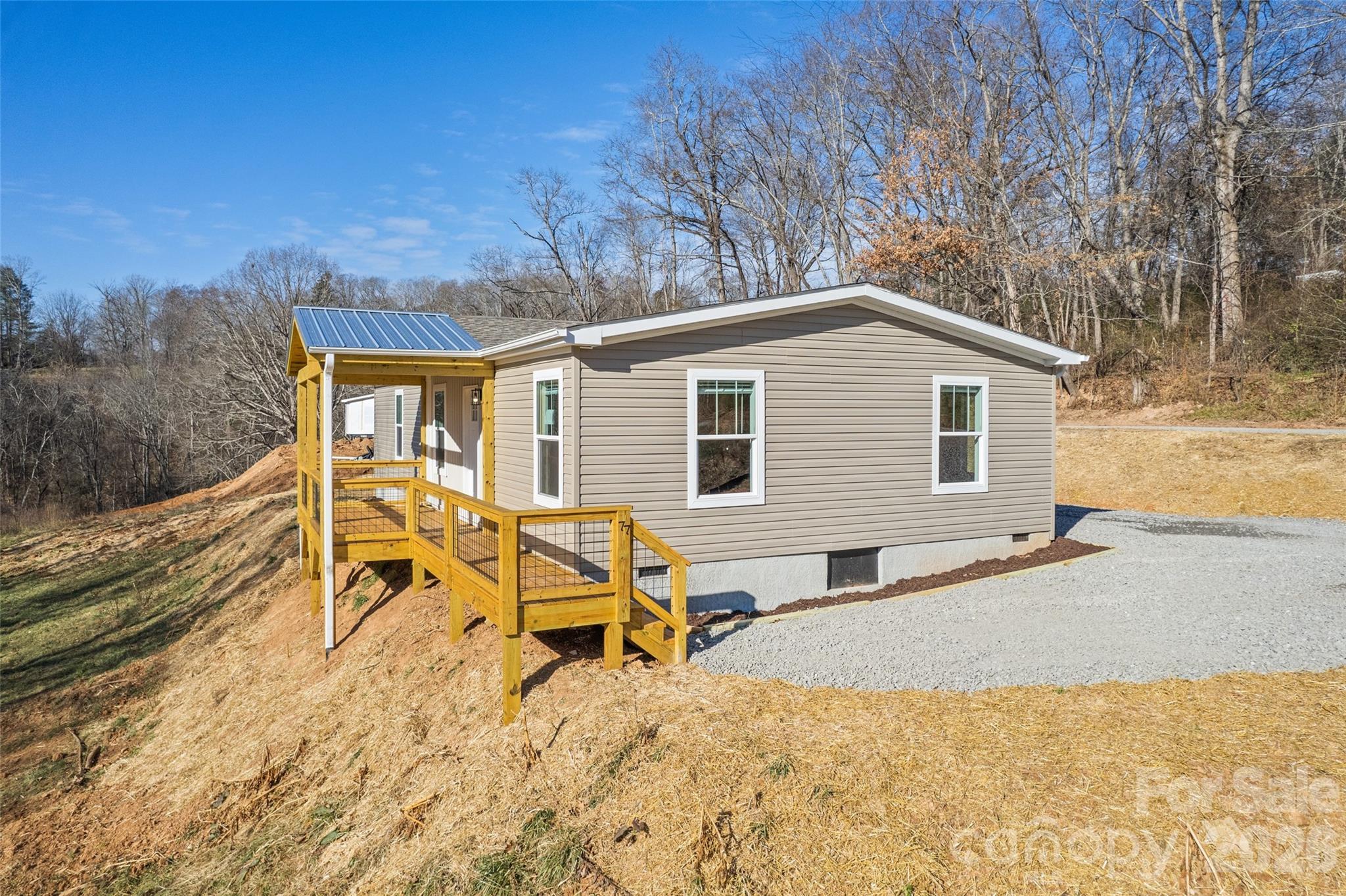 77 Geiranger Drive Clyde, NC 28721 - Photo 25 of 29 a view of a house with yard and sitting area