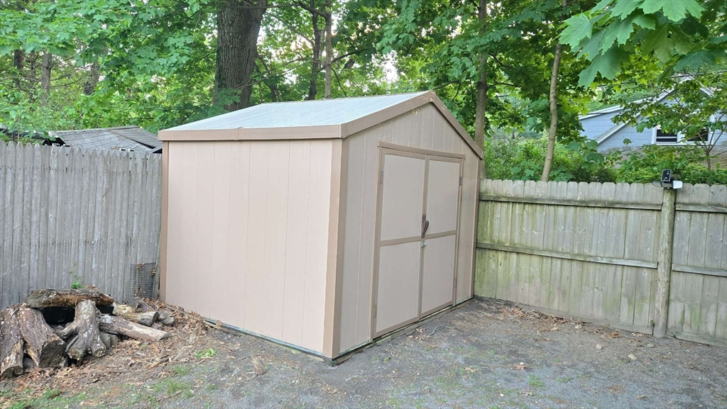 32 Birch Road Natick, MA 01760 - Photo 30 of 38 a view of backyard with small cabin and wooden fence