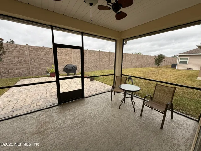 a view of a livingroom with furniture and a floor to ceiling window