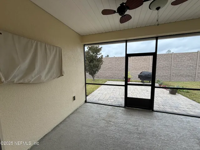 a view of empty room with large windows