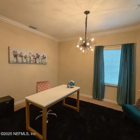 a room with a table chairs and wooden floor