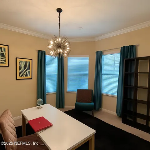 a view of a room with furniture and wooden floor