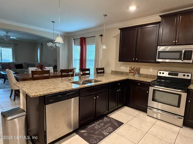 a kitchen with a sink stove and microwave