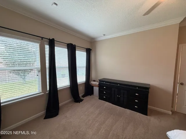 a room with a dresser and a window