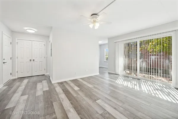a view of a livingroom with wooden floor and white walls