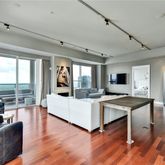 a living room with furniture a wooden floor and a large window