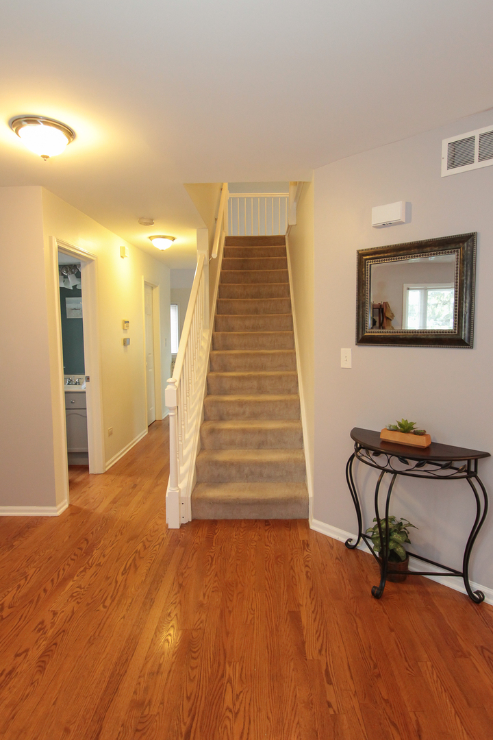 1474 Knotty Pine Drive Elgin, IL 60123 - Photo 4 of 21 a view of a livingroom with wooden floor and stairs