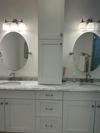 a bathroom with a double vanity sink and a mirror