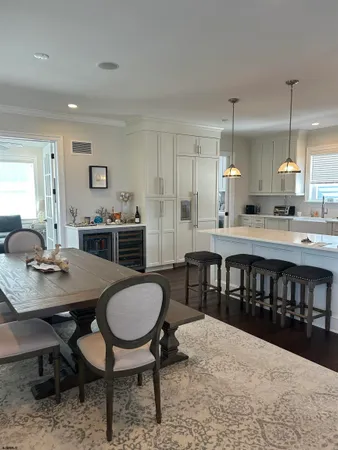 a kitchen with a dining table chairs and sink