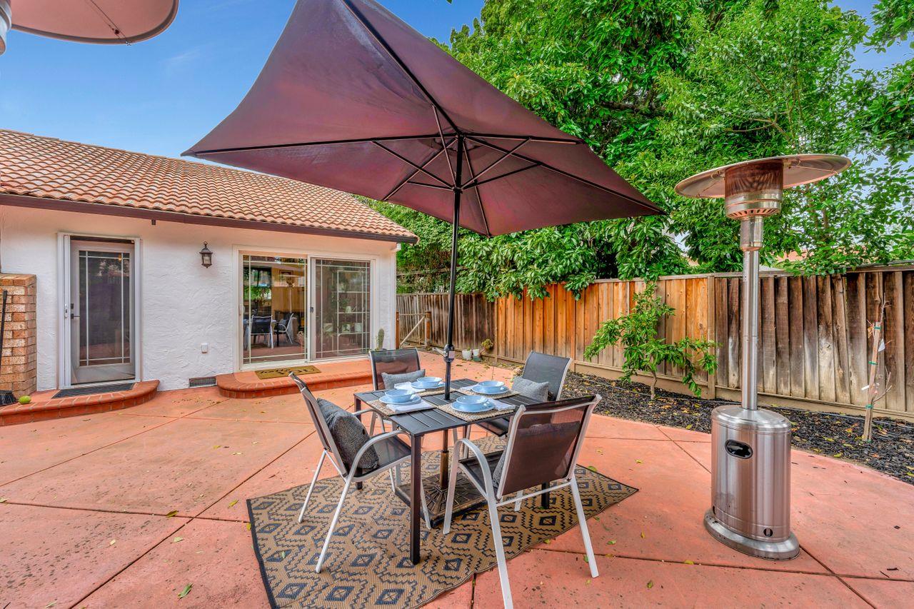 470 Corte Cabanil Morgan Hill, CA 95037 - Photo 37 of 41 a view of a patio with a table and chairs under an umbrella