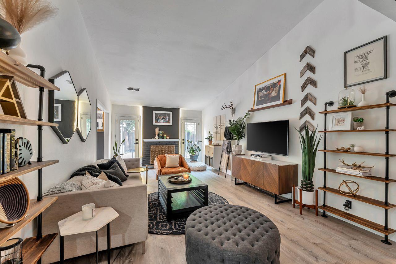 470 Corte Cabanil Morgan Hill, CA 95037 - Photo 8 of 41 a living room with furniture a flat screen tv and gym equipment