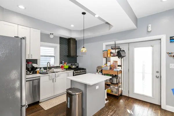 a kitchen with a sink stove and refrigerator