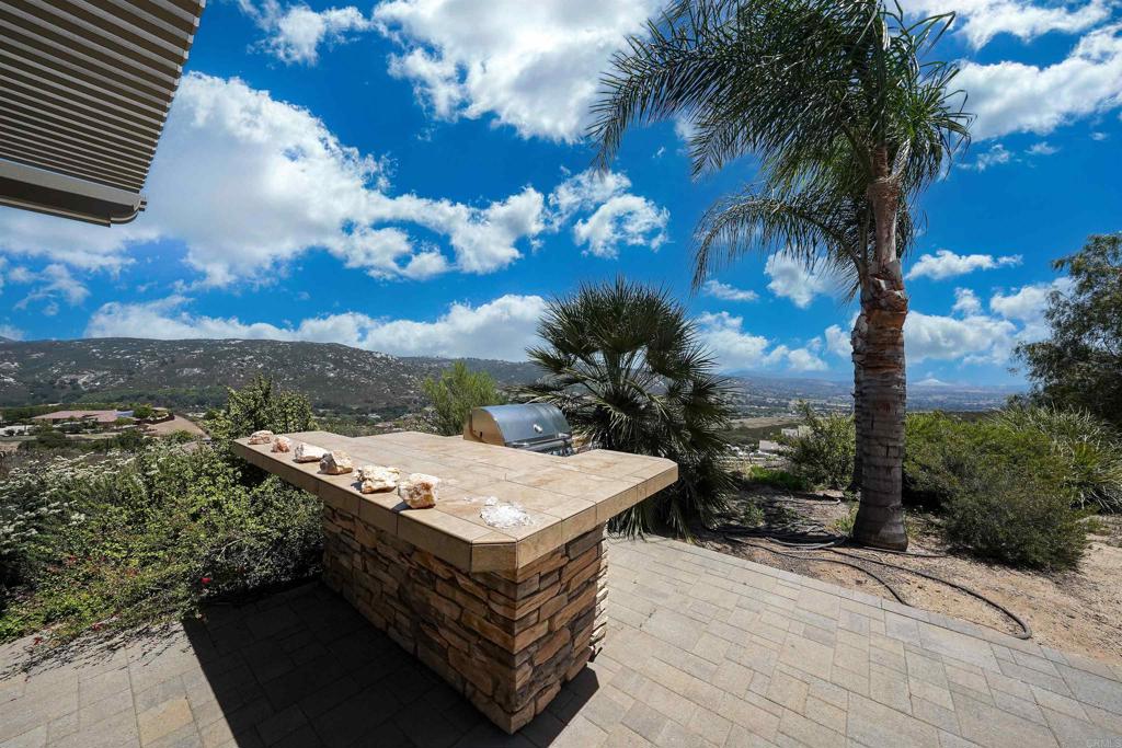22963 Stokes Road Ramona, CA 92065 - Photo 14 of 57 a view of a terrace with a table and chairs