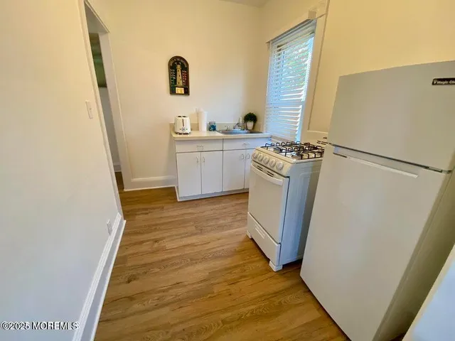 a view of a kitchen from a hallway