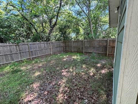 4744 Stokes Street Dallas, TX 75216 - Photo 16 of 20 a view of a backyard with a trees and wooden fence