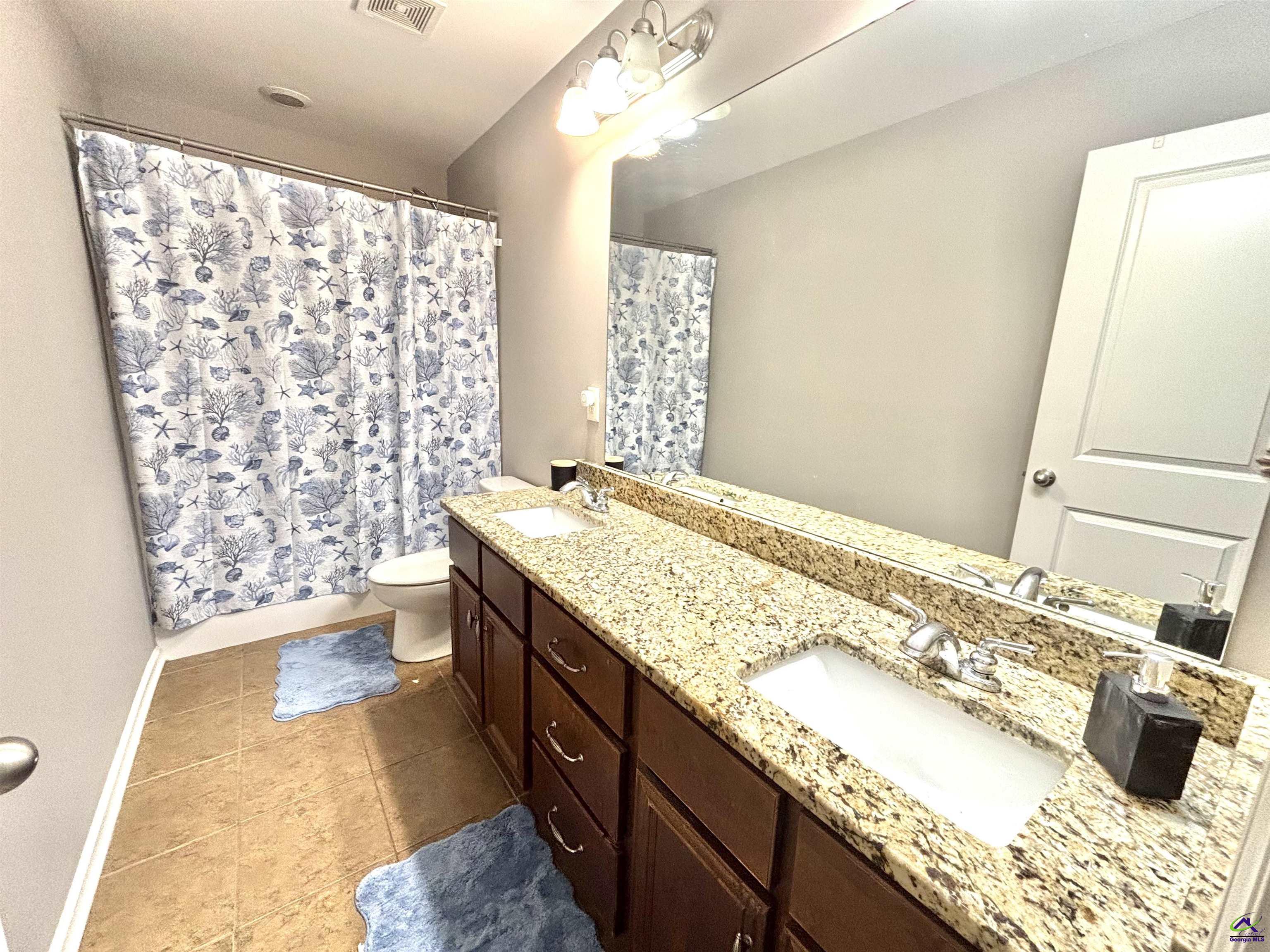 600 Post Oak Way Warner Robins, GA 31088 - Photo 42 of 50 a spacious bathroom with a granite countertop double vanity sink a mirror and shower