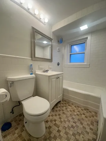 a bathroom with a toilet a sink and bathtub