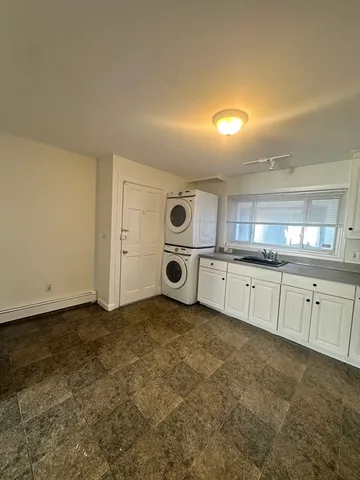 an empty room with a chair and wooden floor