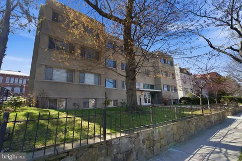 a view of a building with a yard
