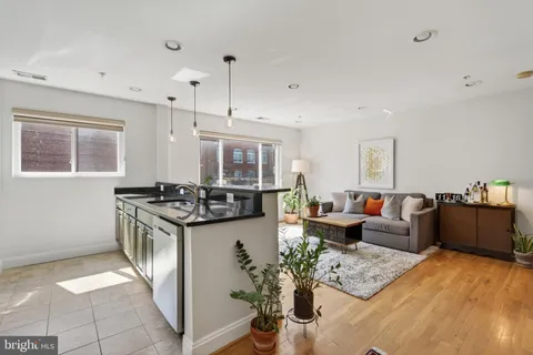 a kitchen with stainless steel appliances granite countertop a stove and a refrigerator