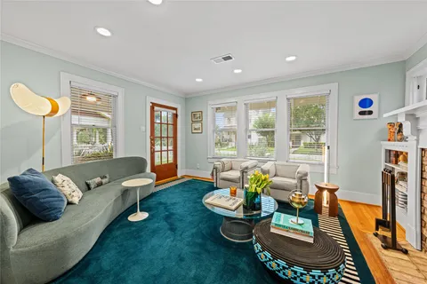 a living room with furniture fireplace and a window