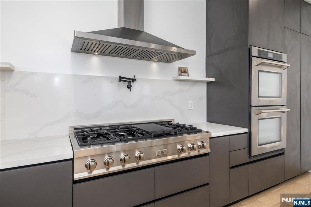 33 Elycroft Parkway Rutherford, NJ 07070 - Photo 11 of 46 a kitchen with granite countertop a stove and a refrigerator