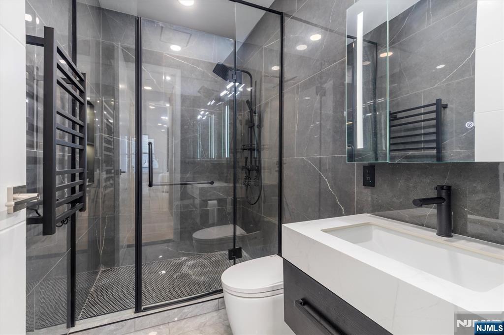 33 Elycroft Parkway Rutherford, NJ 07070 - Photo 15 of 46 a bathroom with a bathtub shower sink vanity and toilet