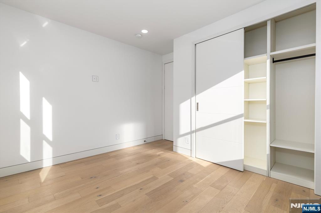 33 Elycroft Parkway Rutherford, NJ 07070 - Photo 17 of 46 an empty room with wooden floor and windows