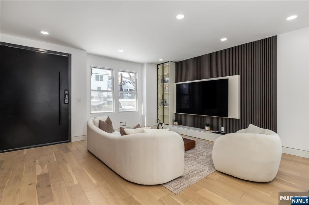 33 Elycroft Parkway Rutherford, NJ 07070 - Photo 2 of 46 a living room with furniture and a flat screen tv