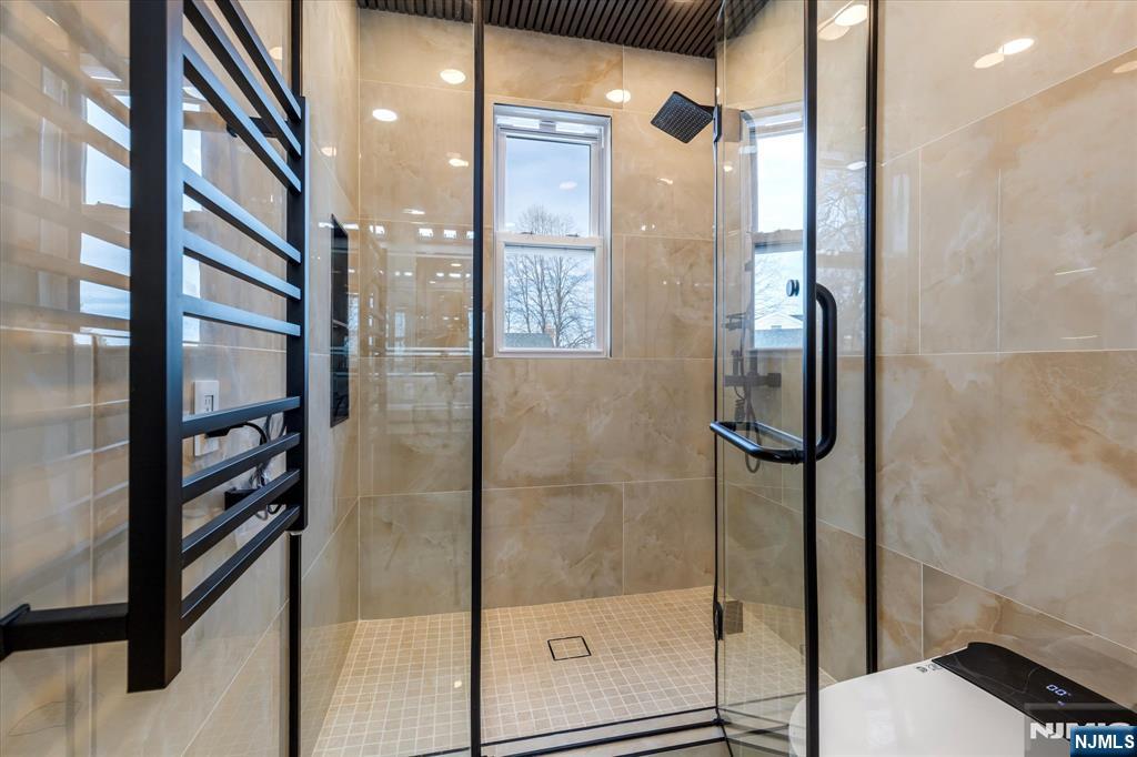 33 Elycroft Parkway Rutherford, NJ 07070 - Photo 26 of 46 a bathroom with a glass shower door